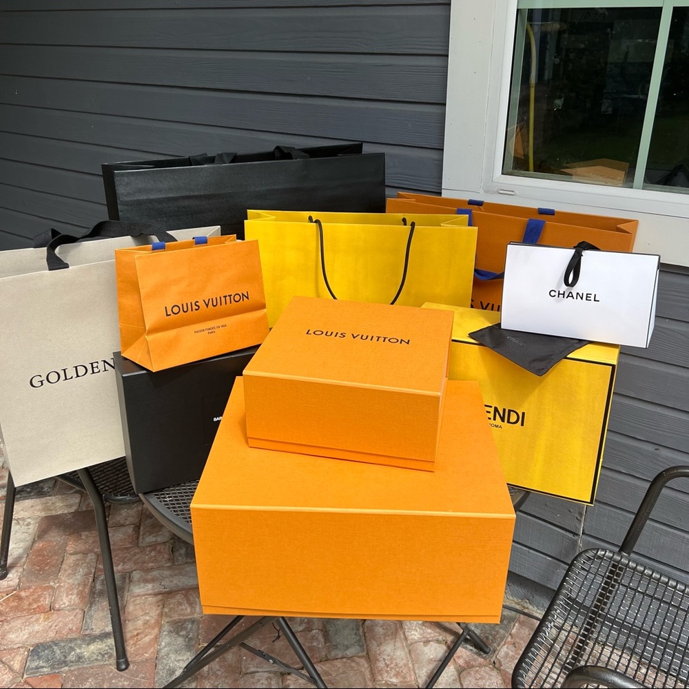 Luxury shopping bags and boxes. Fendi, Louis Vuitton shopping bag, saint laurent